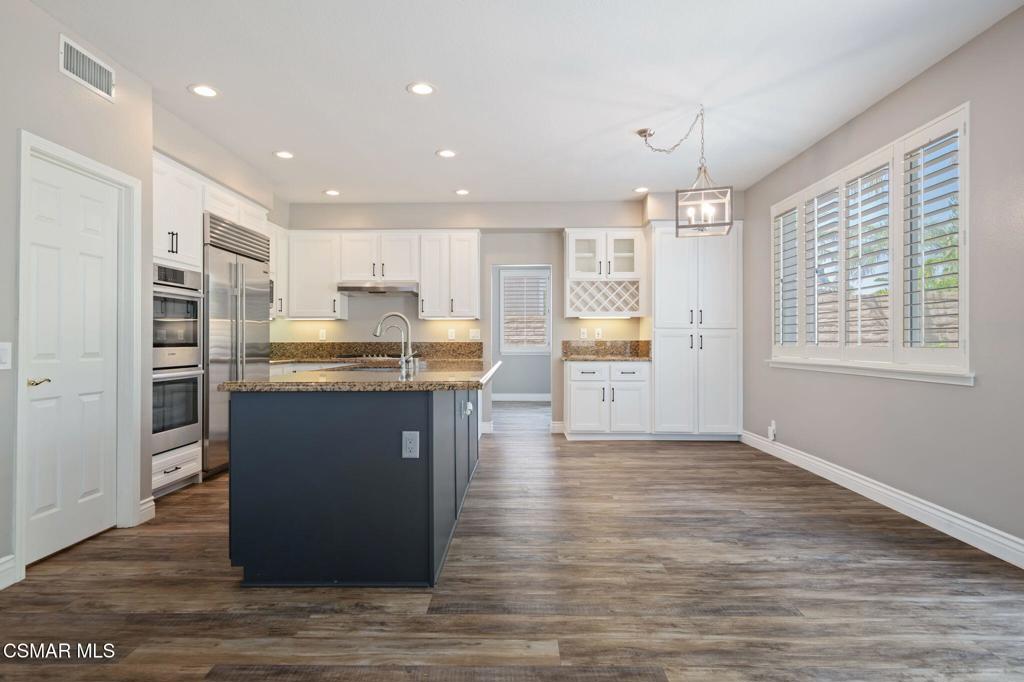 335 Kitetail Street Simi Valley, CA 93065 - Photo 14 of 55 a kitchen with stainless steel appliances granite countertop a refrigerator a sink dishwasher and a stove with wooden floor