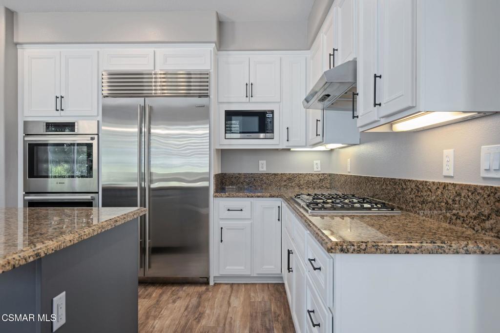 335 Kitetail Street Simi Valley, CA 93065 - Photo 17 of 55 a kitchen with stainless steel appliances granite countertop a sink and a stove