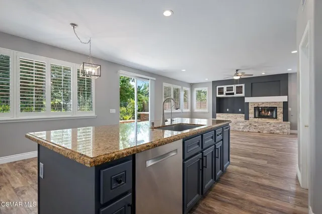 a kitchen with granite countertop a stove and cabinets