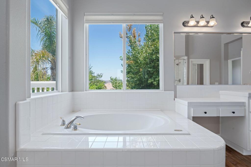 335 Kitetail Street Simi Valley, CA 93065 - Photo 31 of 55 a white bath tub sitting in a bathroom next to a window