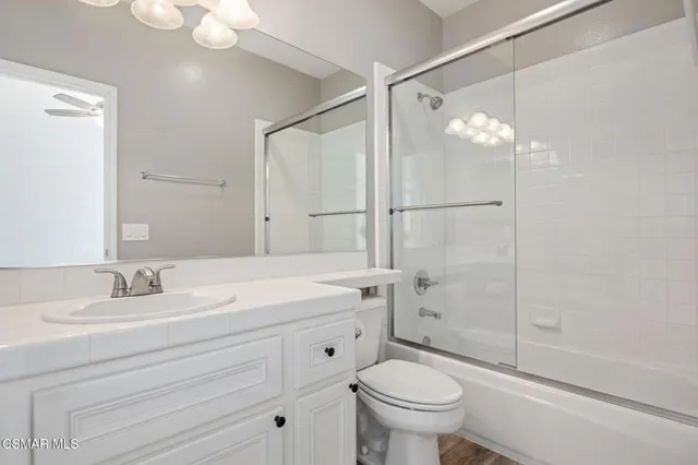 a bathroom with double vanity sink a vanity and mirrors