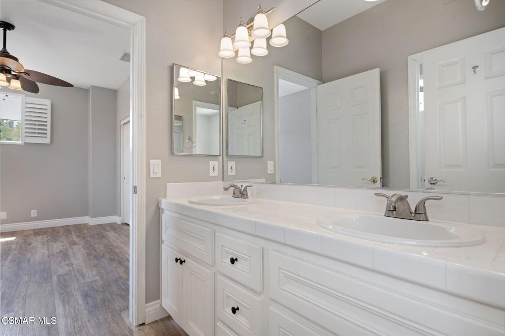 335 Kitetail Street Simi Valley, CA 93065 - Photo 39 of 55 a bathroom with double vanity sink a vanity and mirrors