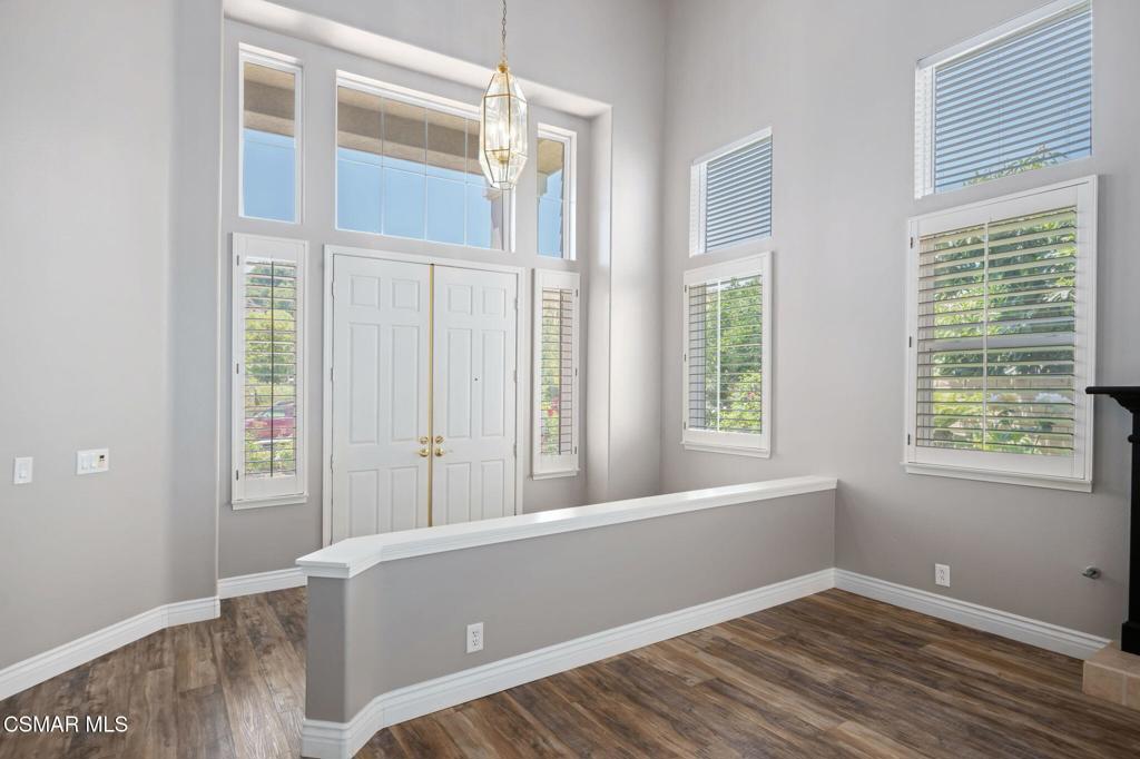335 Kitetail Street Simi Valley, CA 93065 - Photo 5 of 55 a view of an empty room with wooden floor and a window