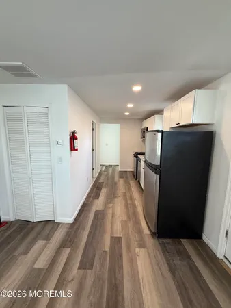a view of a kitchen with wooden floor