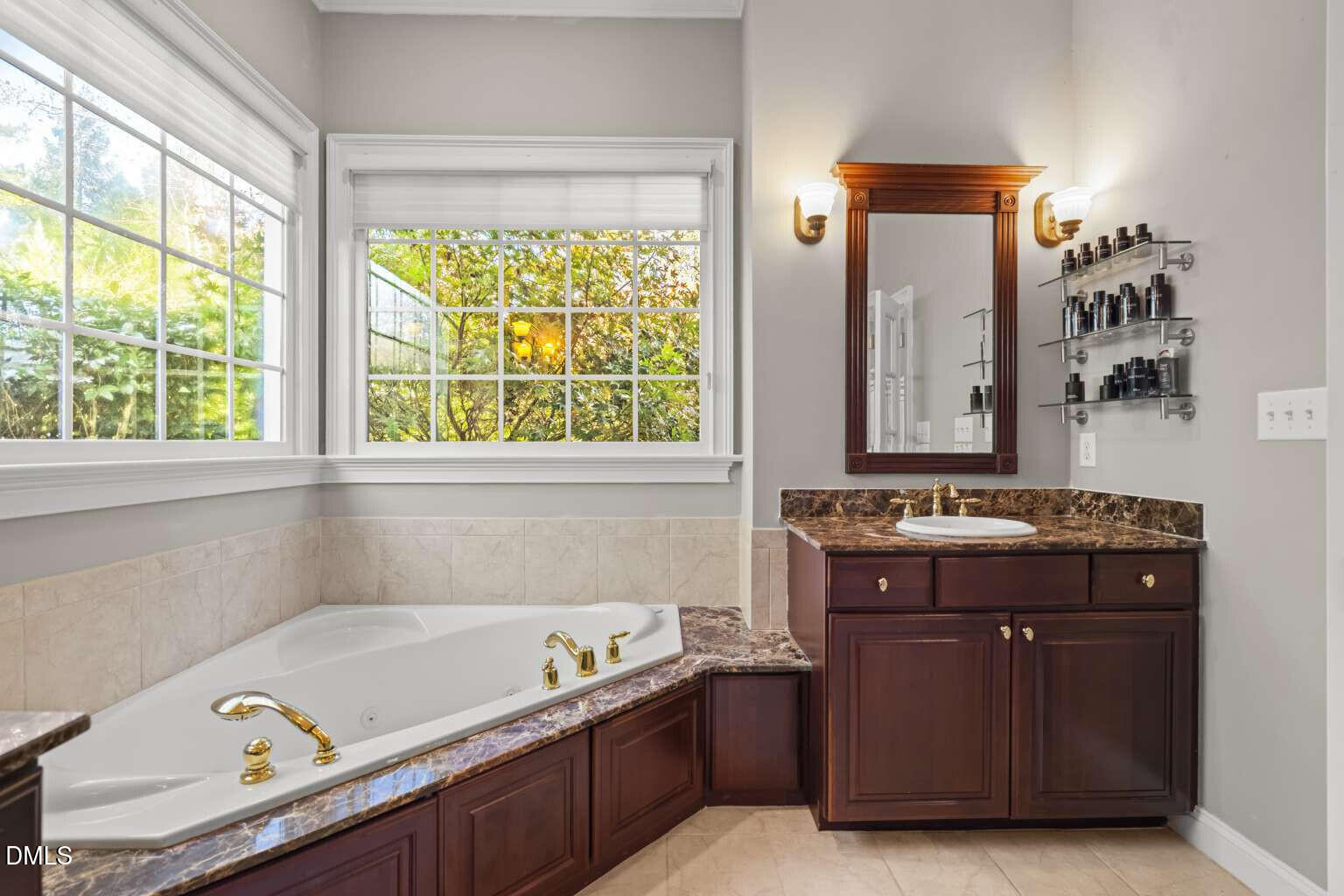 12452 Richmond Run Drive Raleigh, NC 27614 - Photo 36 of 73 a bathroom with a tub sink and mirror