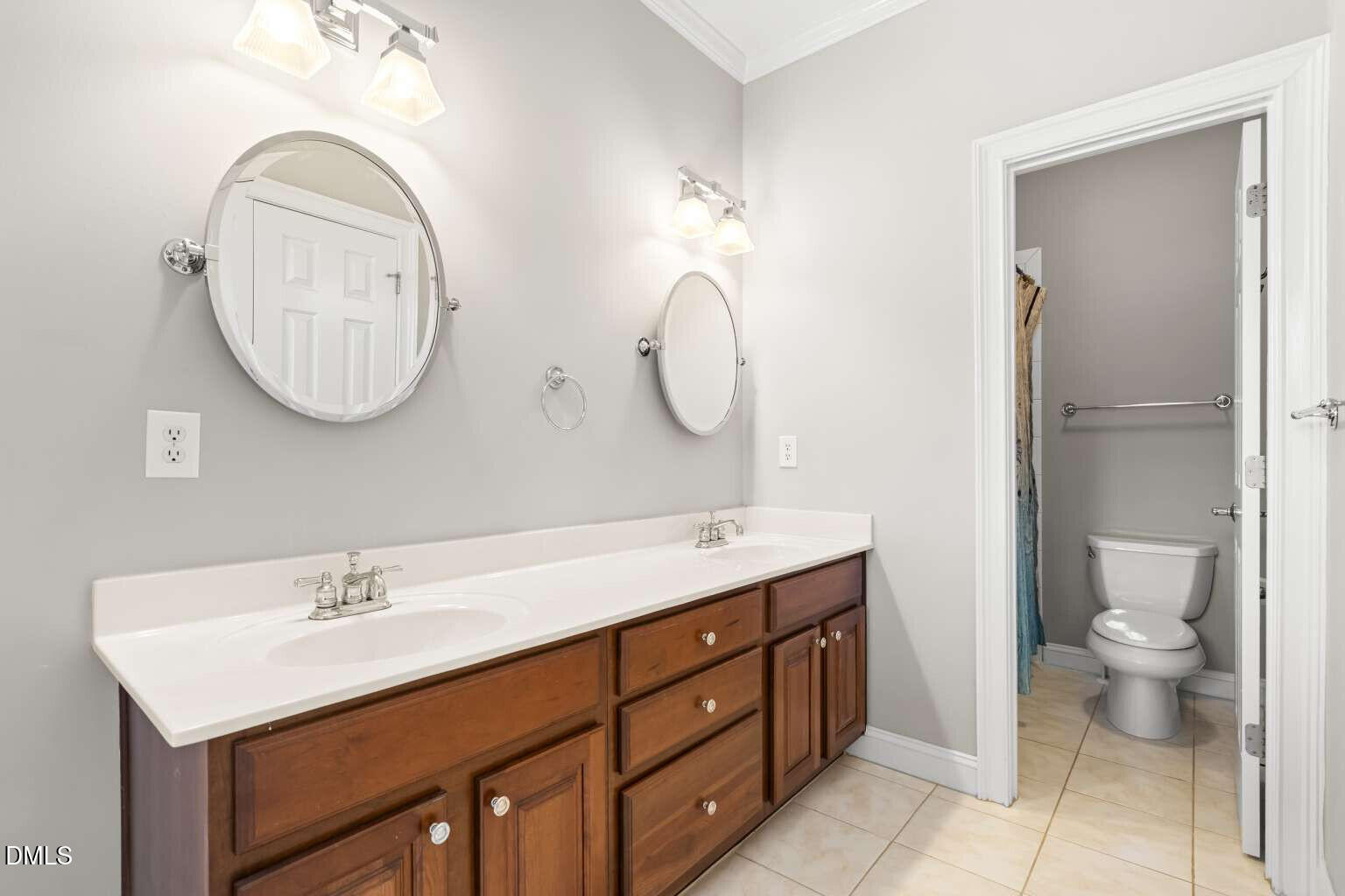 12452 Richmond Run Drive Raleigh, NC 27614 - Photo 42 of 73 a bathroom with a toilet sink and mirror