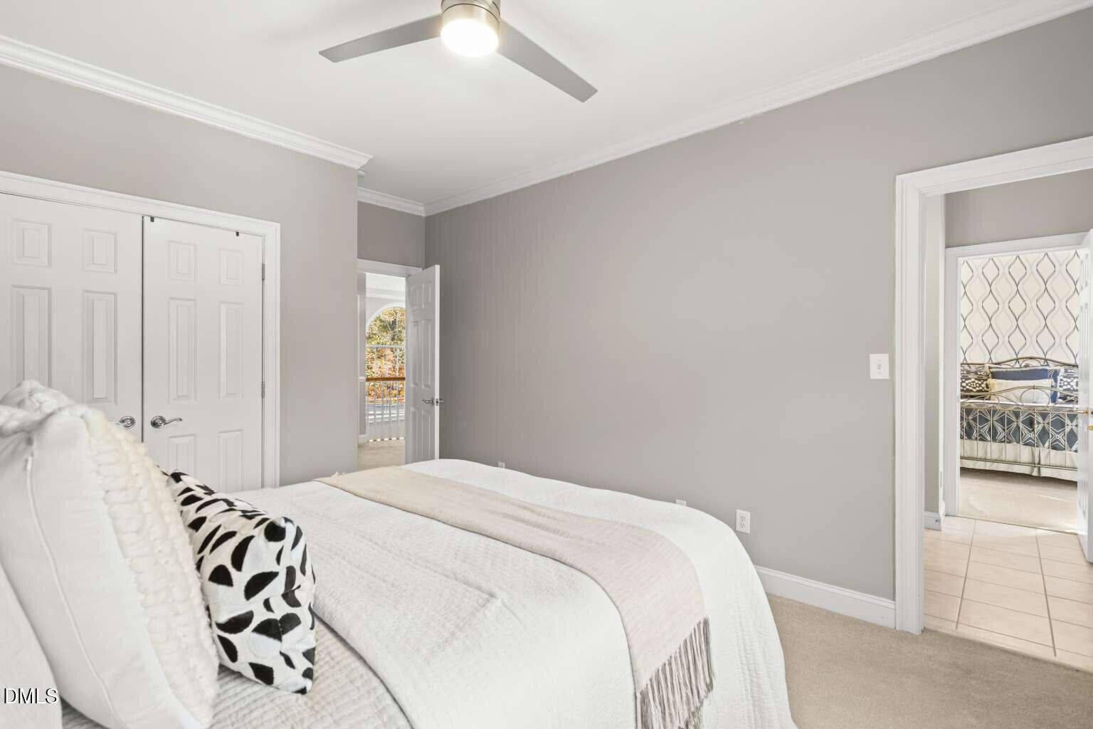 12452 Richmond Run Drive Raleigh, NC 27614 - Photo 44 of 73 a bedroom with a white bed and a chandelier