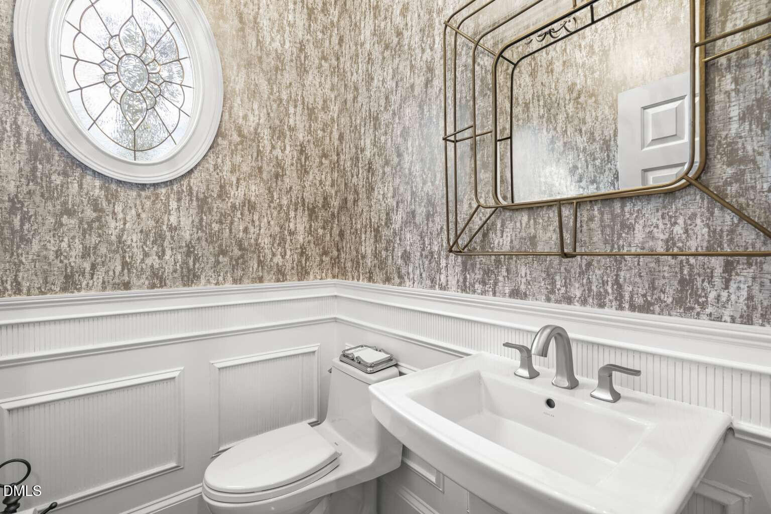 12452 Richmond Run Drive Raleigh, NC 27614 - Photo 7 of 73 a bathroom with a toilet a sink and a mirror