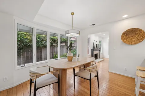 a living room with furniture a fireplace and a potted plant