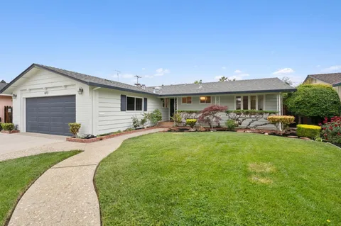 a front view of house with yard and outdoor seating
