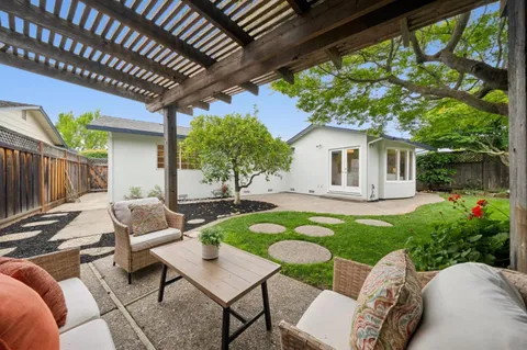a view of a swimming pool with lounge chairs in patio