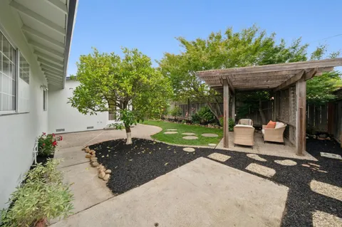an aerial view of house with yard swimming pool and outdoor seating