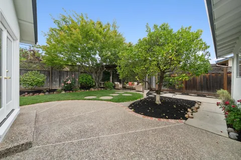 an aerial view of a house with garden space and street view