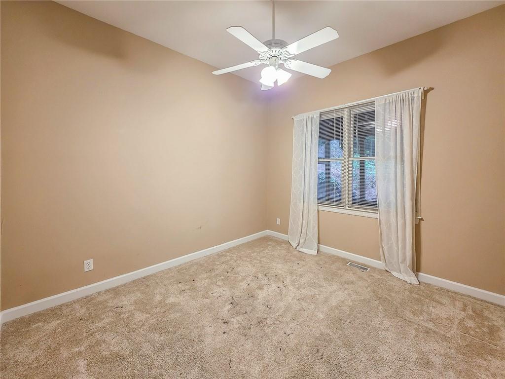 3712 Frederica Road Northwest Berkeley Lake, GA 30096 - Photo 21 of 49 an empty room with chandelier fan