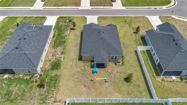 an aerial view of a house with a swimming pool