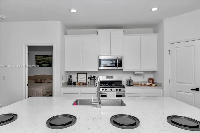 a kitchen with stainless steel appliances wooden cabinets and a sink