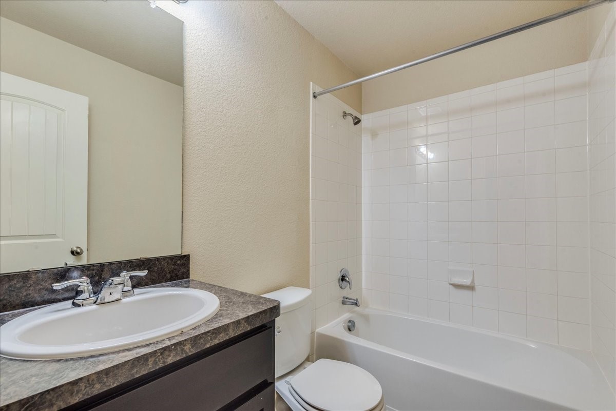 1061 Violet Lane Kyle, TX 78640 - Photo 19 of 34 secondary bathroom with vanity and shower/tub combo