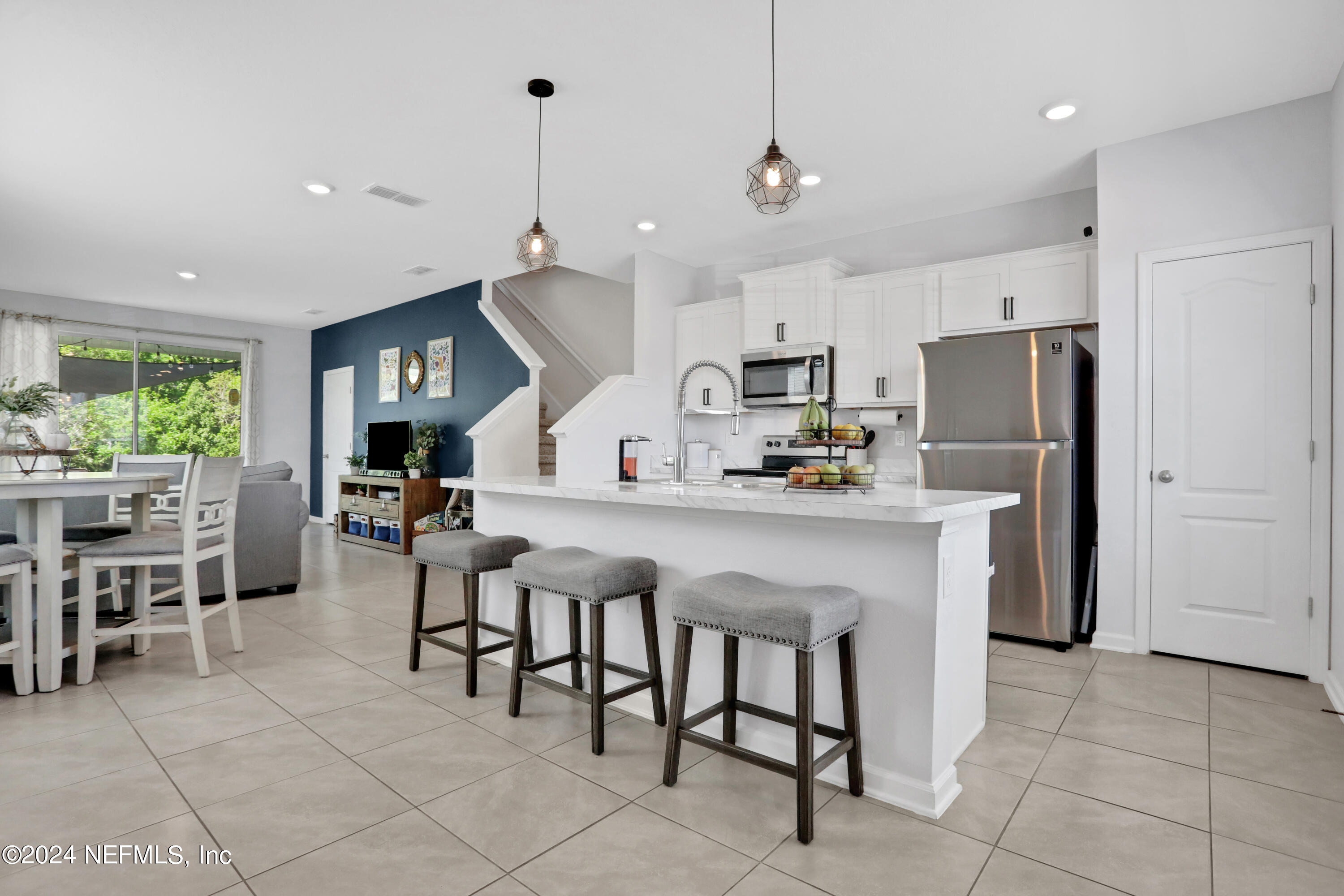 854 Rotary Road Jacksonville, FL 32211 - Photo 1 of 32 a kitchen with granite countertop a table chairs microwave and refrigerator