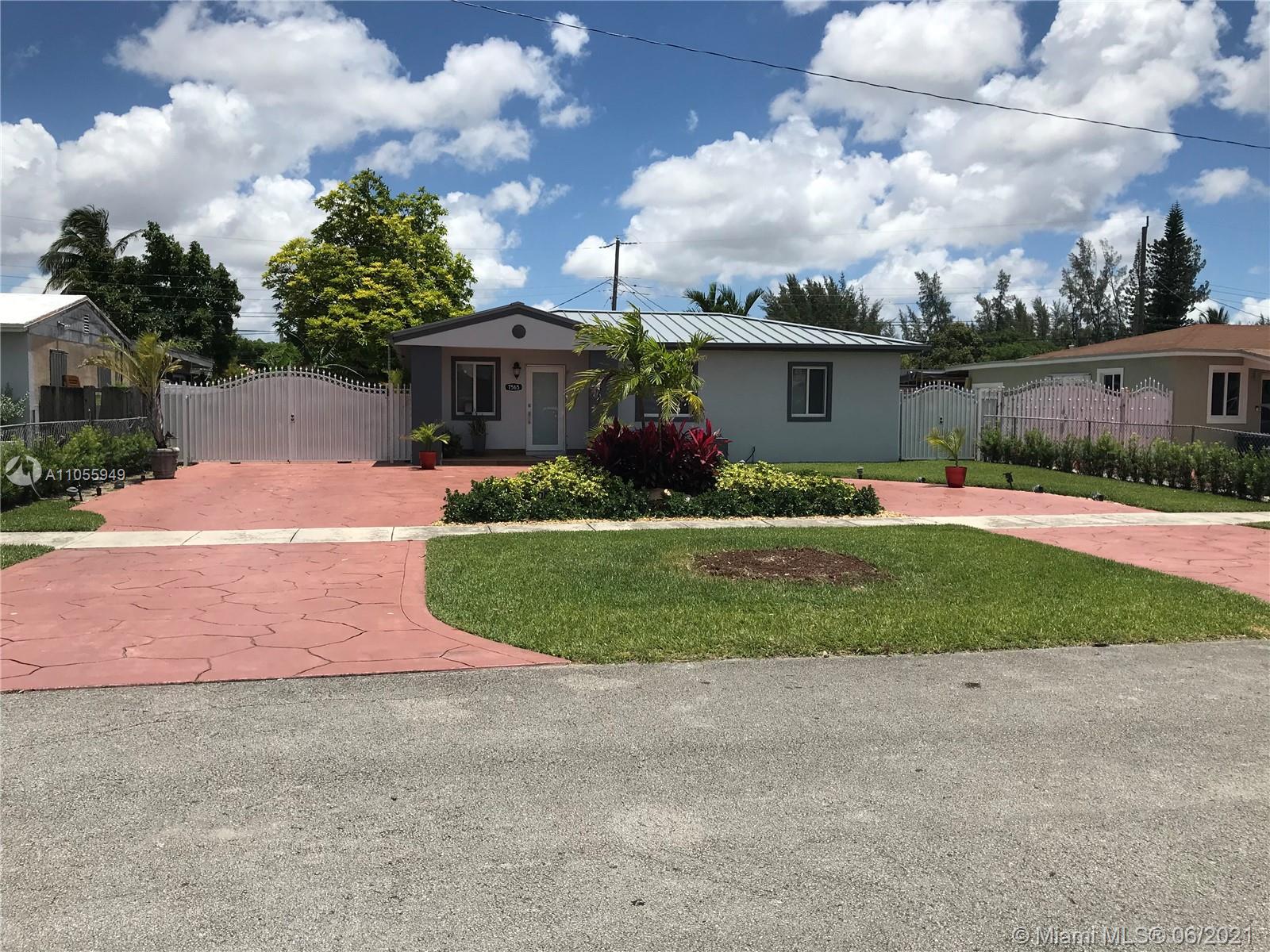 7565 Southwest 28th Street Road Miami, FL 33155 - Photo 2 of 31 a front view of a house with a yard and garage