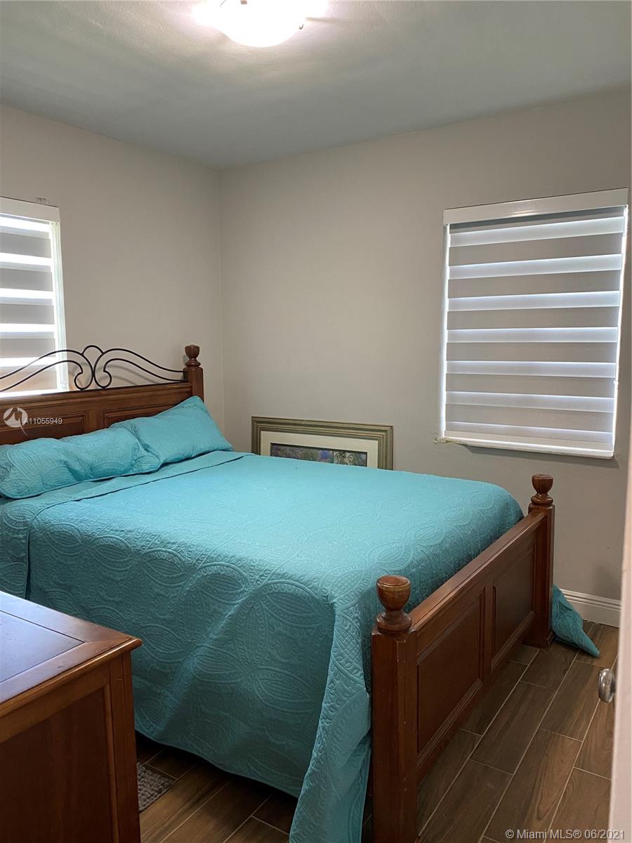 7565 Southwest 28th Street Road Miami, FL 33155 - Photo 15 of 31 a bedroom with a bed and windows