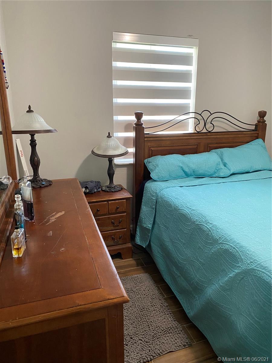 7565 Southwest 28th Street Road Miami, FL 33155 - Photo 16 of 31 a room with a bed and a window