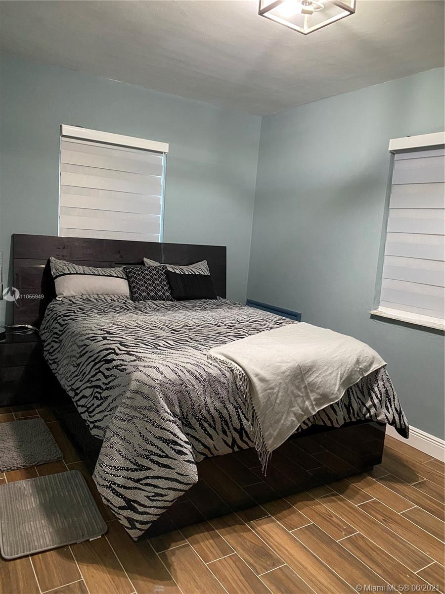 7565 Southwest 28th Street Road Miami, FL 33155 - Photo 18 of 31 a bedroom with a bed and a window