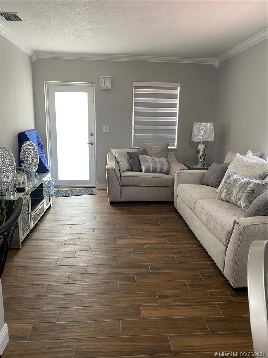7565 Southwest 28th Street Road Miami, FL 33155 - Photo 3 of 31 a living room with furniture and a window