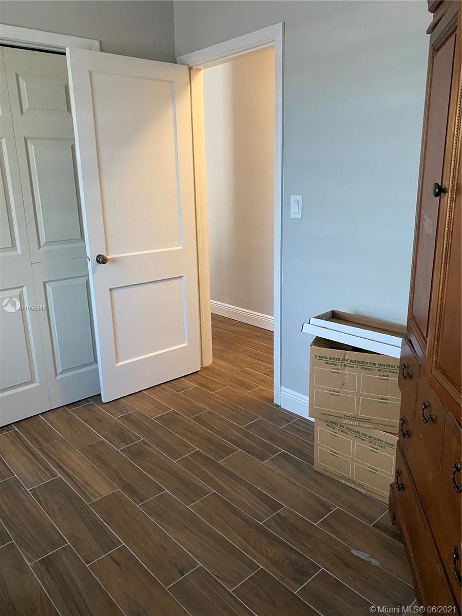 7565 Southwest 28th Street Road Miami, FL 33155 - Photo 21 of 31 a view of empty room with wooden floor