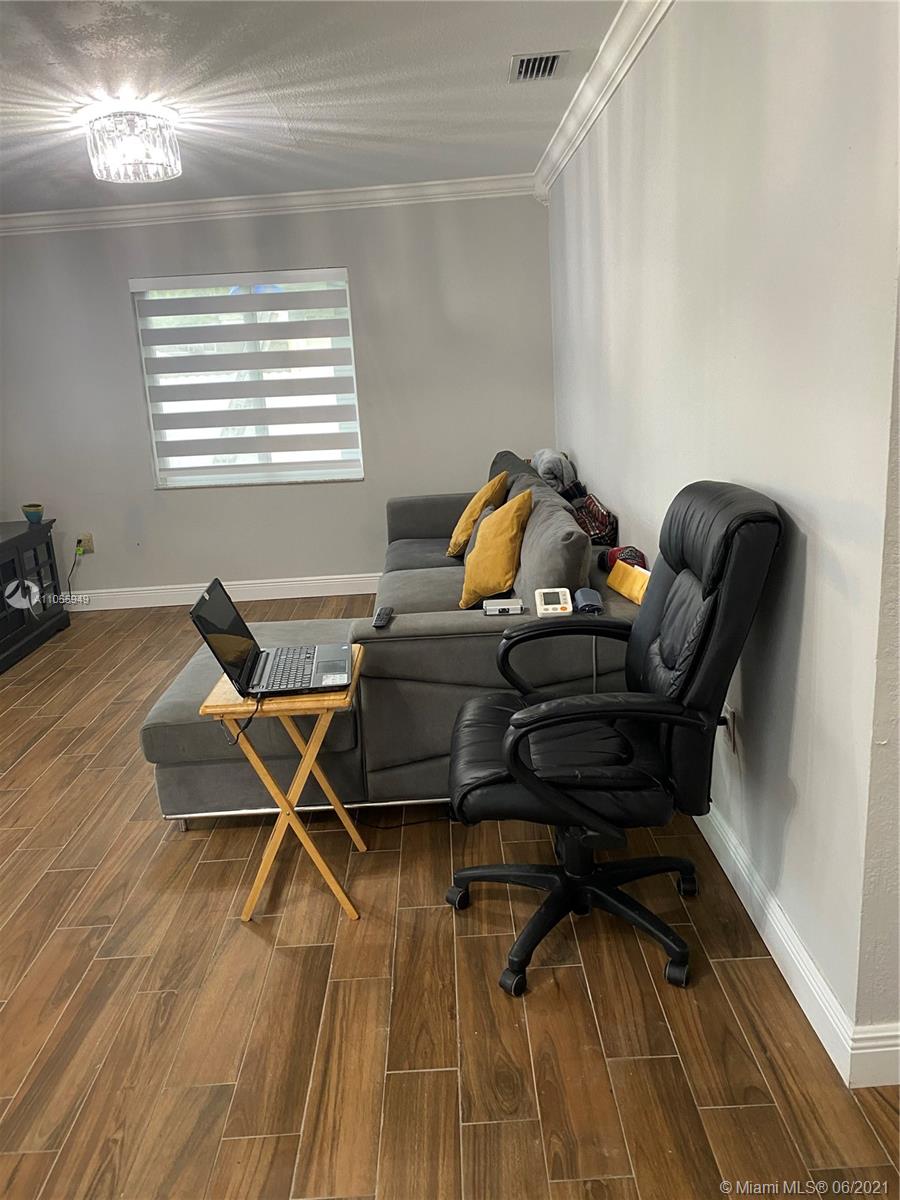 7565 Southwest 28th Street Road Miami, FL 33155 - Photo 23 of 31 a living room with furniture and a wooden floor