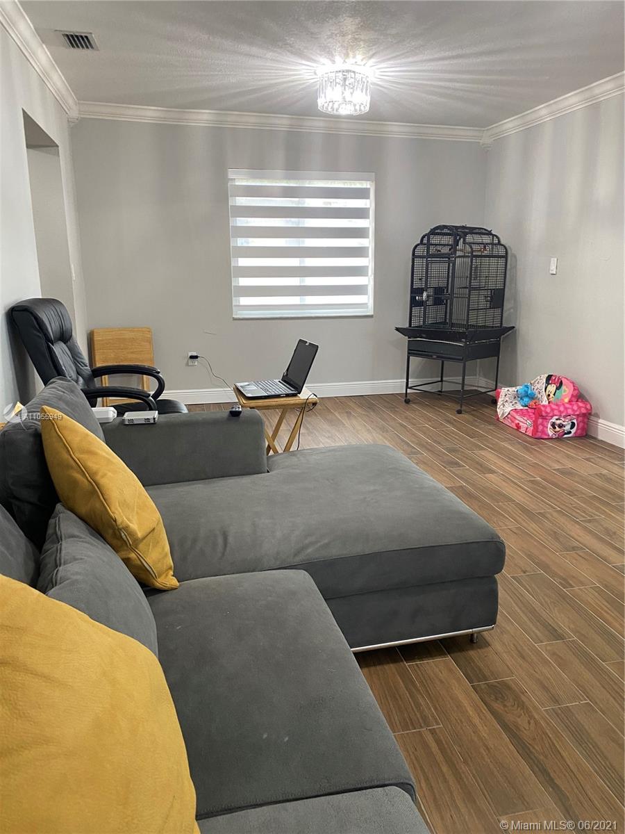 7565 Southwest 28th Street Road Miami, FL 33155 - Photo 24 of 31 a living room with furniture and wooden floor
