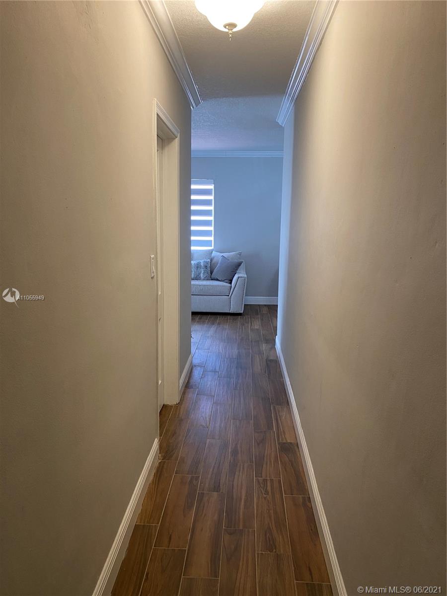 7565 Southwest 28th Street Road Miami, FL 33155 - Photo 5 of 31 a view of bedroom with a bed and wooden floor