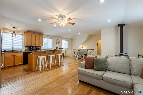 a kitchen with granite countertop stainless steel appliances a stove sink microwave and refrigerator