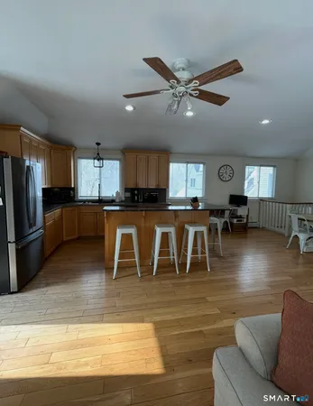 a living room with furniture and a wooden floor