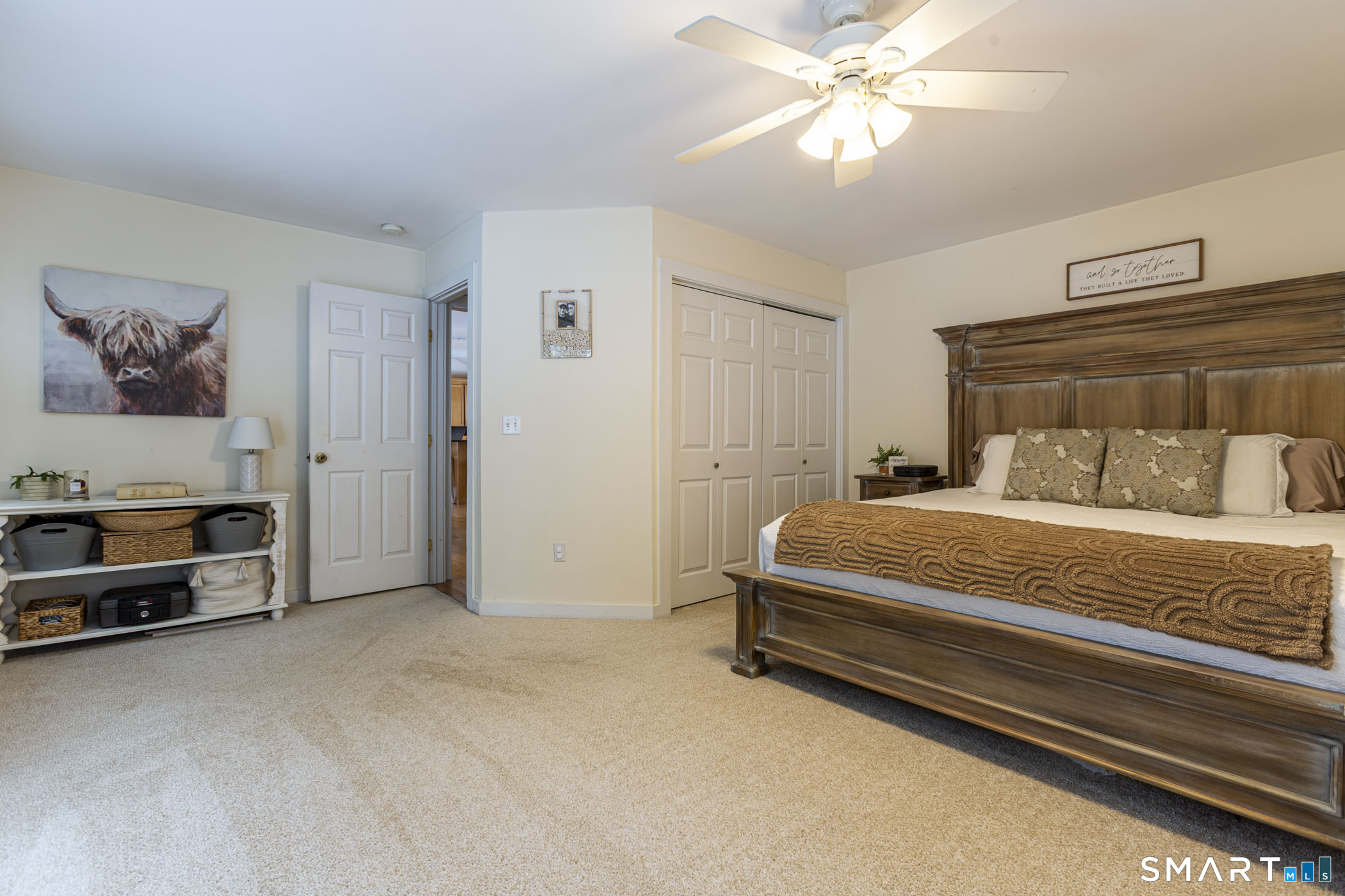 429 Lakeside Road Morris, CT 06763 - Photo 26 of 38 a spacious bedroom with a bed and a chandelier