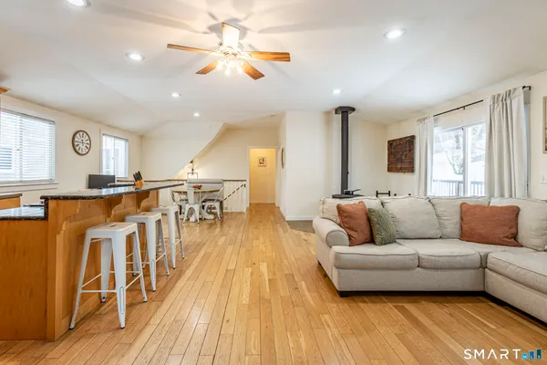 a living room with furniture and a wooden floor