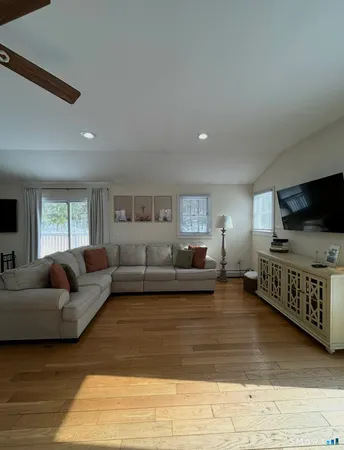 a kitchen with stainless steel appliances granite countertop wooden cabinets a sink and dishwasher with wooden floor