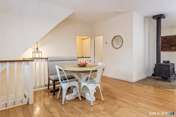 a view of a livingroom with furniture hardwood floor and dining room