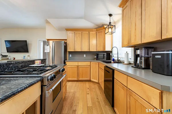 a bathroom with a sink vanity mirror and toilet