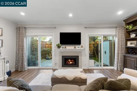 a living room with furniture a fireplace and a flat screen tv