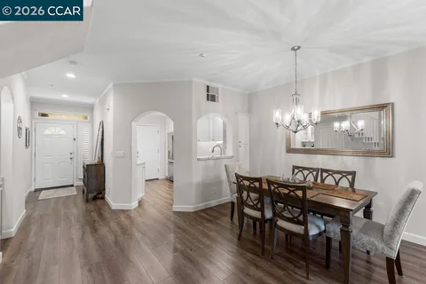 a view of a a dining room with furniture window and wooden floor
