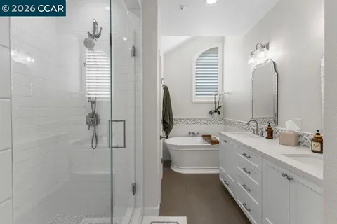 a bathroom with a double vanity sink a mirror and a shower