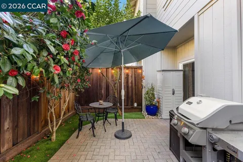 a backyard of a house with table and chairs