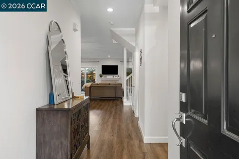 a view of living room with furniture and wooden floor