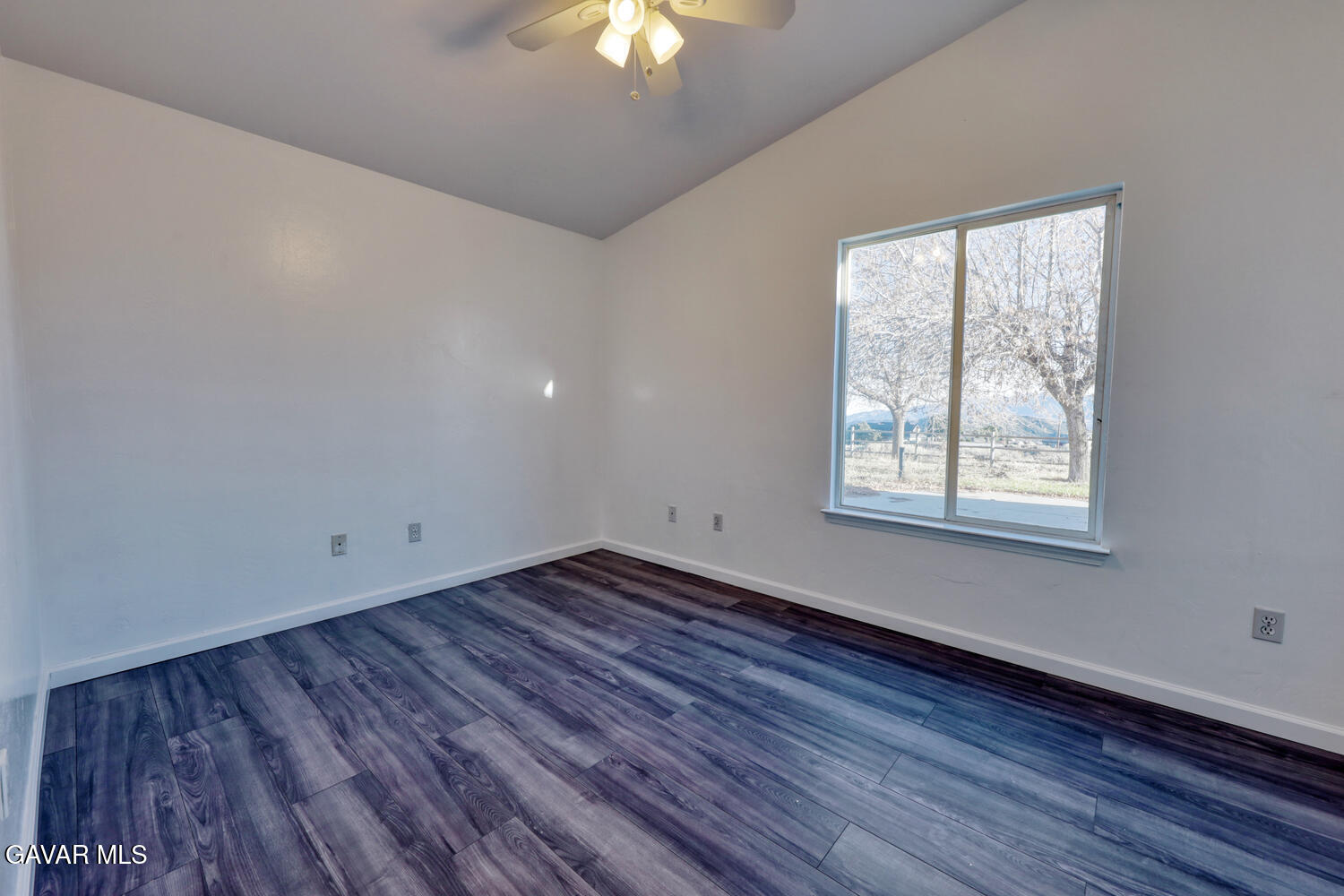26801 Cabriolet Court Tehachapi, CA 93561 - Photo 30 of 60 a view of an empty room with wooden floor and a window