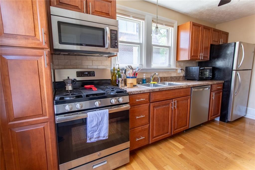 3211 Willett Road Pittsburgh, PA 15227 - Photo 5 of 27 a kitchen with granite countertop cabinets stainless steel appliances and a window