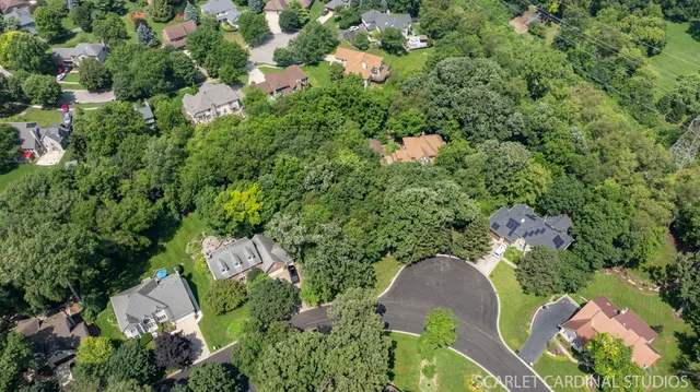 an aerial view of a house with a yard and outdoor seating