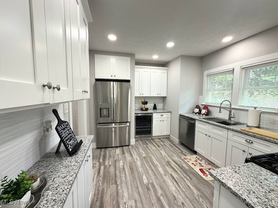 3190 Warrington Road Cleveland, OH 44120 - Photo 3 of 21 Kitchen featuring decorative backsplash, white cabinets, recessed lighting, and a textured ceiling