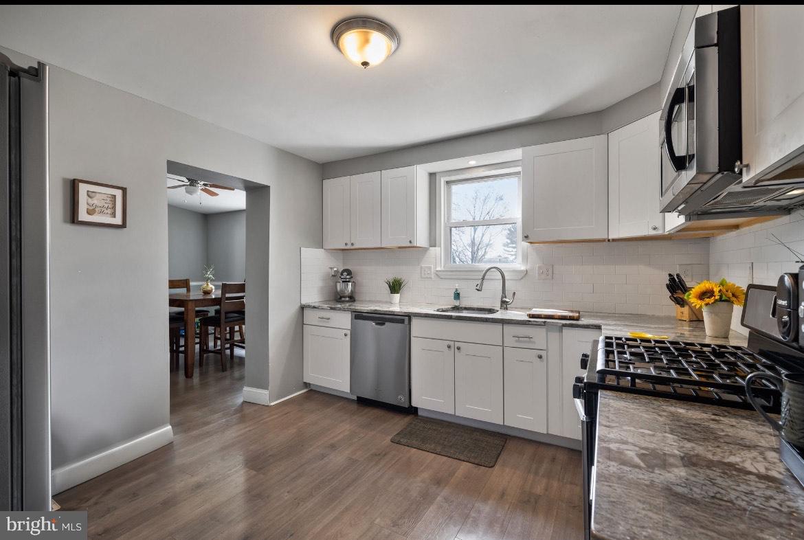 404 Pine Street Williamstown, NJ 08094 - Photo 13 of 24 a kitchen with a sink cabinets and wooden floor