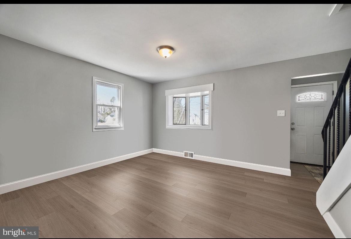 404 Pine Street Williamstown, NJ 08094 - Photo 14 of 24 a view of an empty room with wooden floor and a window