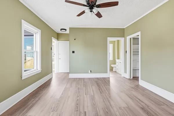 wooden floor in an empty room with a window